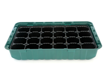 Seed tray module for sowing seeds isolated on white background. Gardening equipment green and black using eco friendly recycled plastic. Isolated on white background.