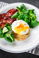 egg poached fesh breakfast bacon, green leaves salad healthy meal food snack on the table copy space food background rustic top view