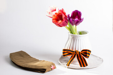 a military cap with a red star and blue carnations on memorial day. May 9th Holiday