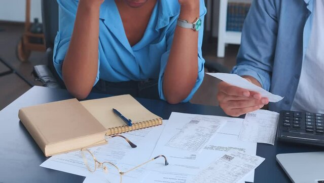 Hands of office workers sits at table with calculator and financial documents coordinating financial budget for marketing or calculating amount of tax deductions to submit declaration. Close up