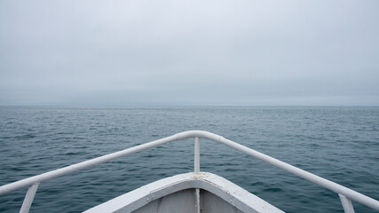 On the bow of the boat. Along the coast of the Kamchatka 