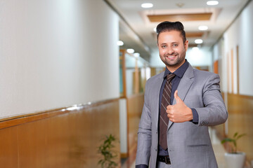 Indian businessman showing thumps up