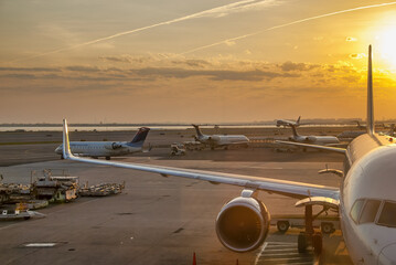 New York City - April 2009: Airplanes at sunset along the runway at JFK international airport