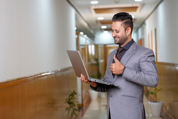 Indian businessman using laptop at office.