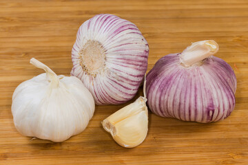 Bulbs and cloves of the garlic on a wooden surface