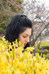 girl with brown hair and white face with yellow spring flowers