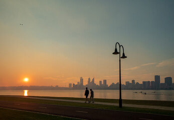 Sunset on the South Perth foreshore, looking towards Perth City Skyline on a hazy day
