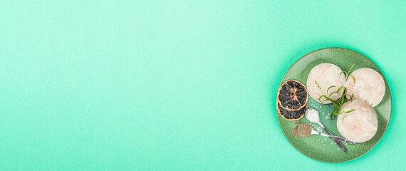Chunks of frozen hake. Marine fish fillet on stone background, raw ingredient for cooking food