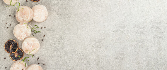Chunks of frozen hake. Marine fish fillet on stone background, raw ingredient for cooking food