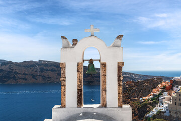 White bell tower in Oia. Santorini, Greece.