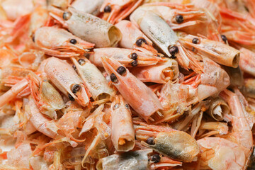 remains of shrimp shells on a plate, leftover food