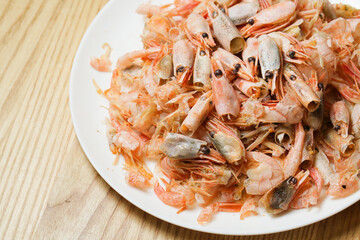 remains of shrimp shells on a plate, leftover food