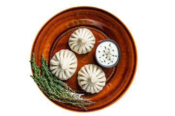 Obraz na płótnie Canvas Khinkali Dumplings with beef and lamb meat on rustic plate with herbs. Isolated, transparent background