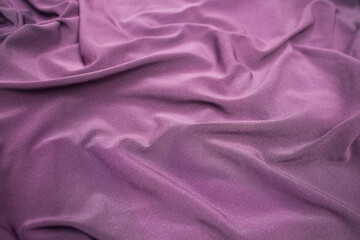 background and texture of wavy bright purple fabric