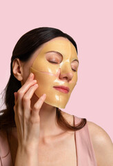 Woman uses a hydrogel mask on her face. Procedure at the cosmetologist. Face care and beauty treatments. Hydrogel face mask with collagen, hyaluronic acid for glowing skin.