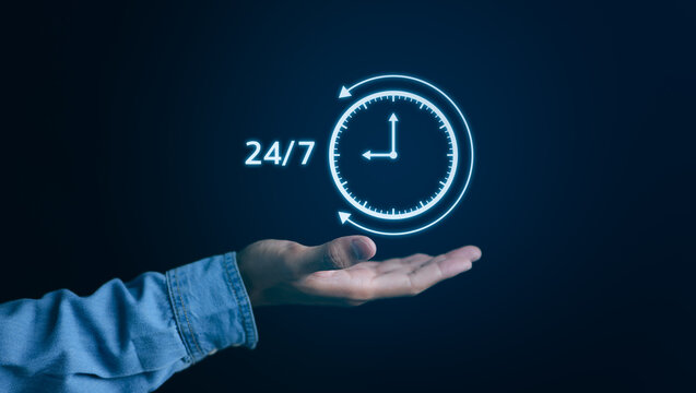 Nonstop service 24 hr concept. businessman hand holding virtual 24-7 with clock on hand for worldwide nonstop and full-time available contact of service concept. Assistance customer services,