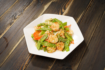 Sautéed Shrimp with Snow Peas on Simple Background