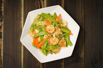 Sautéed Shrimp with Snow Peas on Simple Background