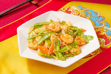 Sautéed Shrimp with Snow Peas on Simple Background