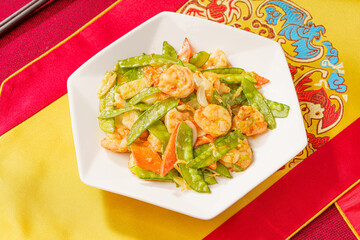 Sautéed Shrimp with Snow Peas on Simple Background
