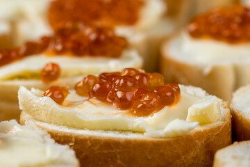 Thinly sliced baguette with salmon caviar and butter