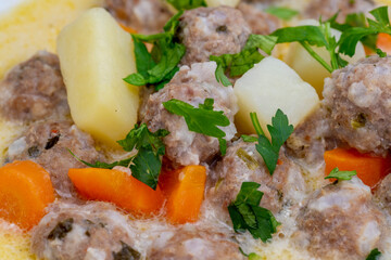 Meatballs with potatoes, carrots and yogurt.