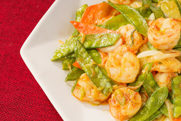 Sautéed Shrimp with Snow Peas on Simple Background