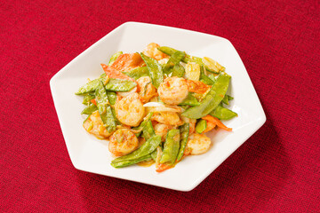 Sautéed Shrimp with Snow Peas on Simple Background