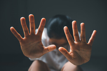 Stop violence against women concept, international women's day. Female hand raised in fear and stop sexual harassment. Women are depressed by bullying and abuse. family threat