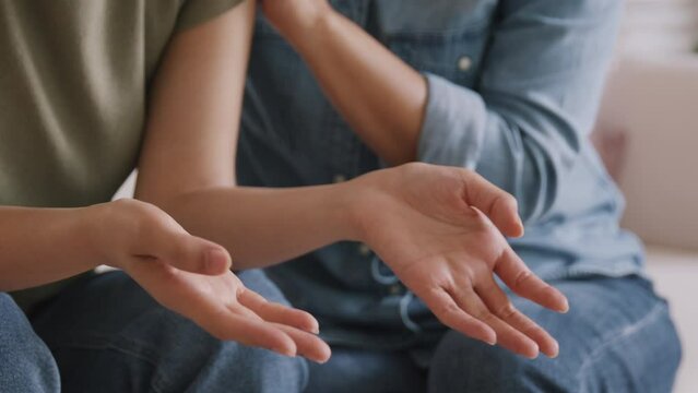 Middle aged asia people old mom holding hands trust comfort help young woman talk crying stress relief at home. Mum as friend love care hold hand adult child feel pain sad worry of life crisis issues.