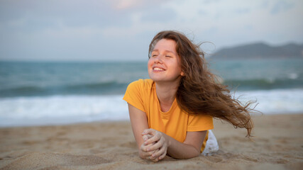 Portrait of happy girl, young carefree woman enjoying summer vacation on sea, walking on beach sand, smiling and having fun in tropical country, relaxing on nature. Summertime, happiness concept.
