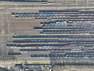 Aerial drone footage top down view of a picturesque locomotive depot with a vast array of tracks and trains.