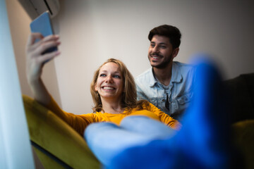 couple in love taking selfie smiling and having fun at home