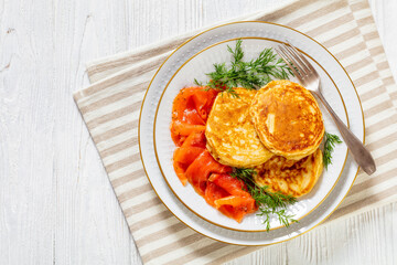 pancakes with sliced cold smoked salmon, top view