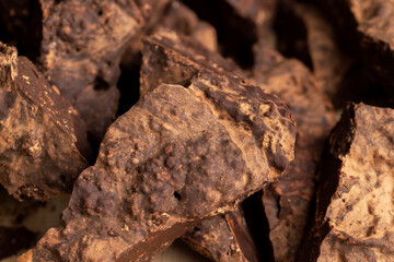 Pieces of chocolate with added cocoa and sugar