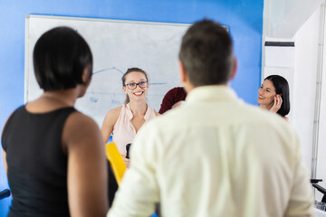 Multiracial business people working together at boardroom table at office. Successful team of colleagues brainstorming.