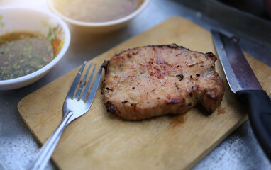 A close-up of a whole homemade pork steak is a simple holiday and family activity.