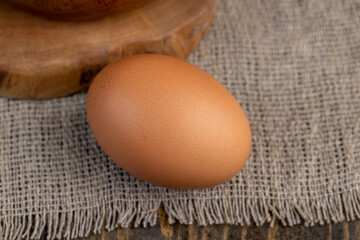 A whole orange chicken egg close-up on the table