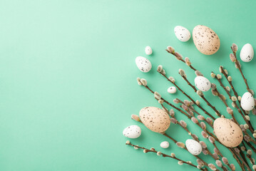 Easter concept. Top view photo of bunch of pussy-willow and easter eggs on isolated teal background with copyspace