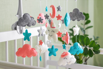 Colorful and eco-friendly children's mobile from felt for children. It consists of toys clouds, stars and moon. Handmade