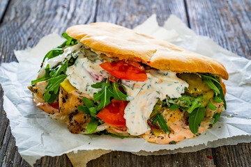 Kebab - grilled meat, bread and vegetables on wooden table
