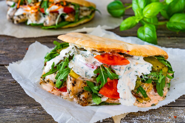 Kebab - grilled meat, bread and vegetables on wooden table
