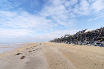 Fototapeta na wymiar Beach and riprap of Hauteville-sur-Mer village in the Cotentin coast