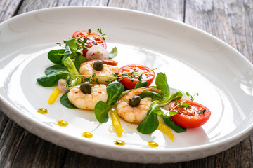 Prawn salad on wooden table
