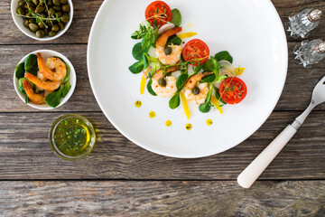 Prawn salad on wooden table
