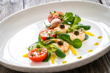 Prawn salad on wooden table
