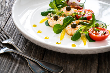 Prawn salad on wooden table
