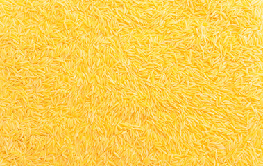 Background texture of dried risoni, orzo pasta. Italian cuisine. Durum wheat semolina pasta for risotto and salads. Orzo pasta of rice shape. Closeup, horizontal plane, top view, flatly.