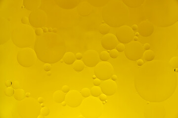 Yellow abstract background with oil circles, streaks and gradient.