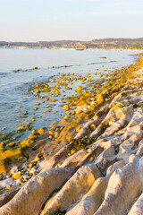 Morning atmosphere at Lake Garda. The water level is historically low, so rocks and stones on the...